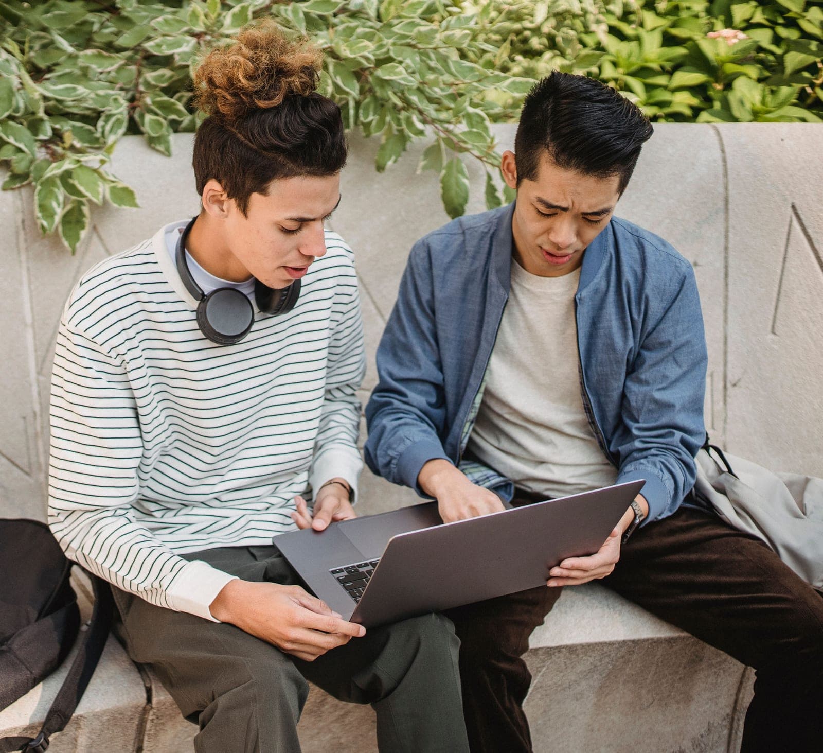 Two students looking at a laptop together